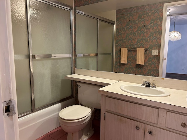 full bathroom featuring tile patterned floors, toilet, vanity, and combined bath / shower with glass door