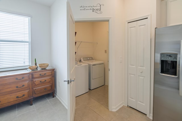 laundry area featuring separate washer and dryer and light tile patterned flooring