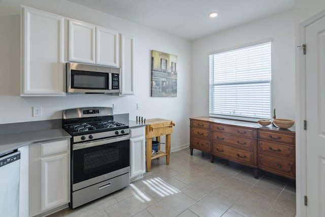 kitchen with white cabinetry, light tile patterned floors, and appliances with stainless steel finishes