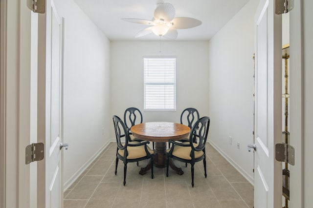 tiled dining room featuring ceiling fan