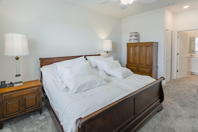 bedroom featuring ceiling fan, carpet, and connected bathroom