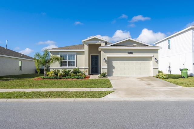 view of front of property with a front yard and a garage