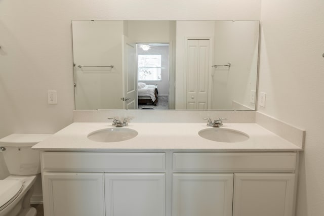 bathroom featuring vanity and toilet