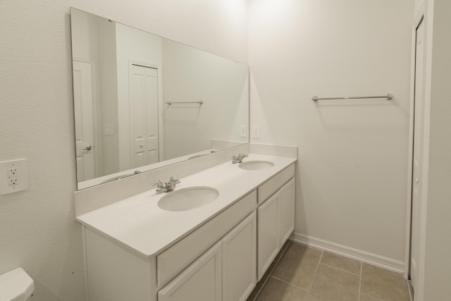 bathroom featuring tile patterned floors, vanity, and toilet