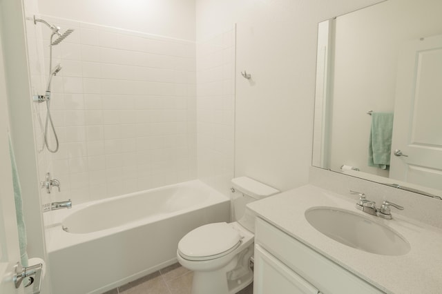 full bathroom featuring vanity, tile patterned flooring, tiled shower / bath, and toilet