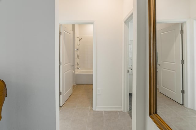 hall featuring light tile patterned floors