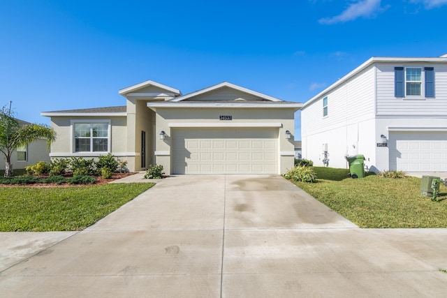 ranch-style home with a garage and a front lawn