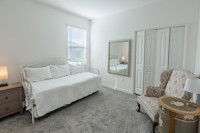 bedroom featuring light colored carpet and a closet