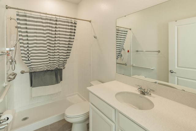 bathroom featuring tile patterned floors, a shower with curtain, vanity, and toilet