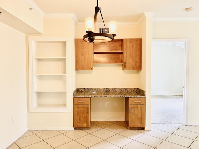 kitchen featuring crown molding, light tile patterned flooring, pendant lighting, and ceiling fan with notable chandelier