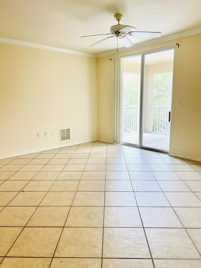 spare room featuring ceiling fan, light tile patterned floors, and ornamental molding