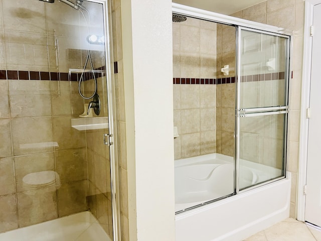 bathroom featuring tile patterned flooring and enclosed tub / shower combo