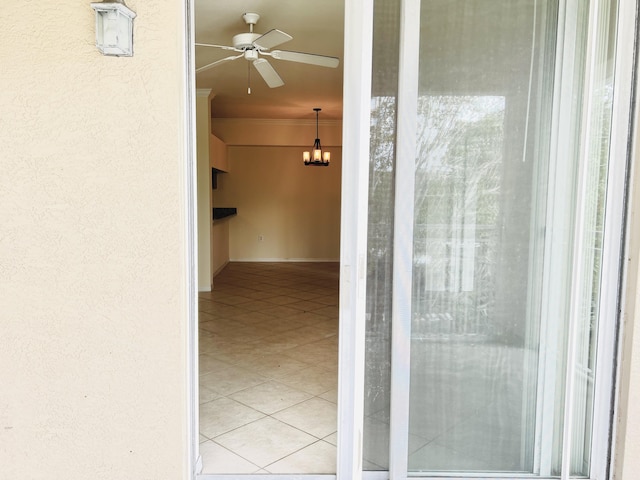 doorway to property with ceiling fan