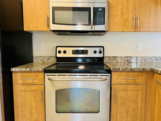 kitchen with stainless steel appliances and light stone counters