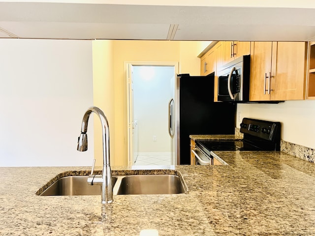 kitchen featuring range with electric stovetop, sink, and light brown cabinets