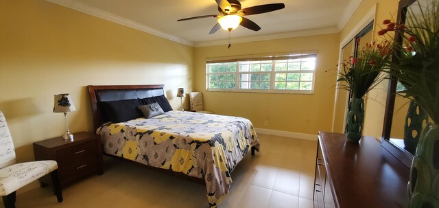 bedroom with ceiling fan and ornamental molding