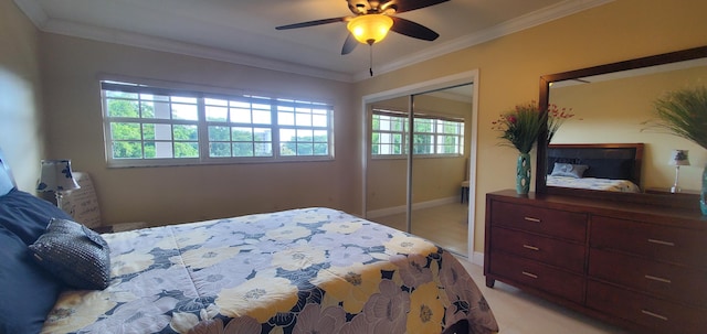 bedroom featuring multiple windows, ceiling fan, a closet, and ornamental molding