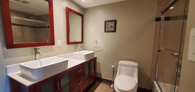 full bathroom with vanity, toilet, and combined bath / shower with glass door