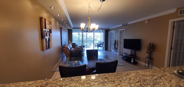 dining room featuring crown molding and a notable chandelier