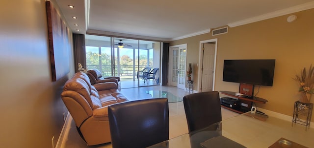 living room with ceiling fan and ornamental molding