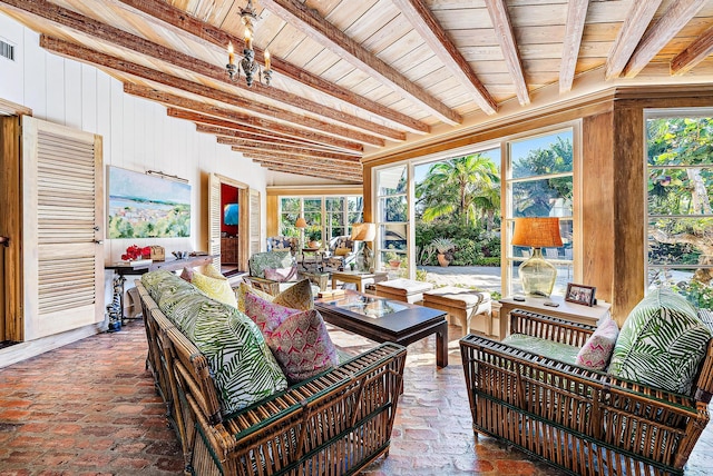 sunroom / solarium featuring beam ceiling, wood ceiling, and a wealth of natural light