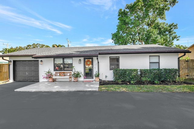 single story home featuring a porch and a garage