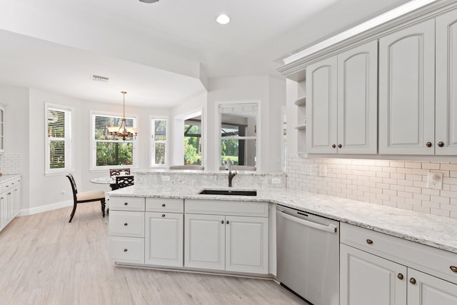 kitchen featuring dishwasher, light wood-type flooring, a chandelier, and sink