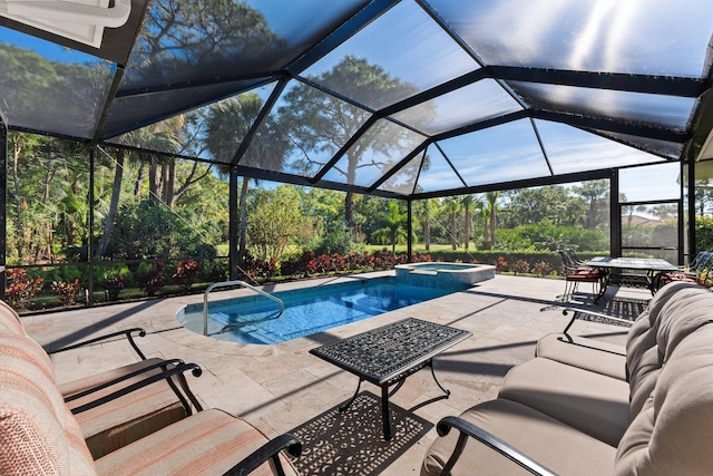 view of pool featuring an in ground hot tub, glass enclosure, and a patio area