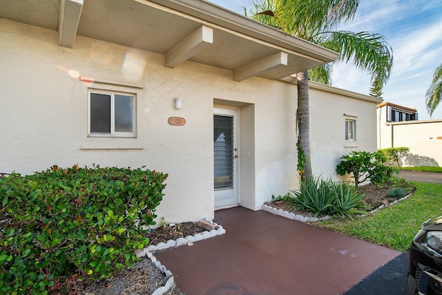 property entrance featuring a patio