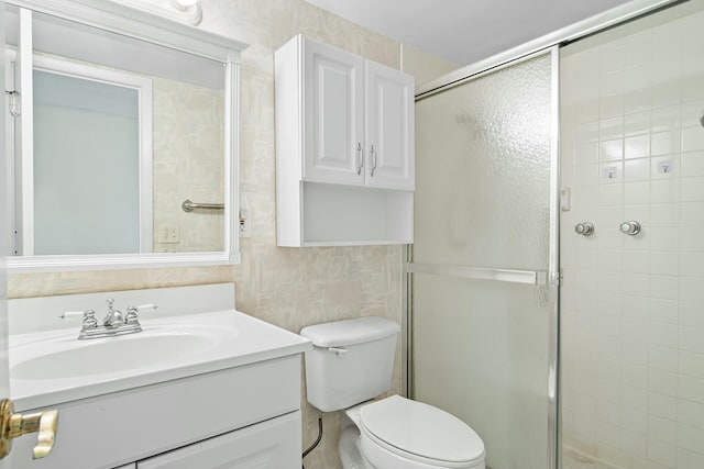 bathroom featuring vanity, toilet, and an enclosed shower