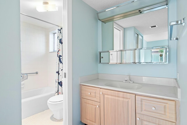 full bathroom featuring vanity, tile patterned flooring, toilet, a textured ceiling, and shower / tub combo