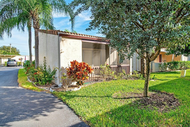 view of side of property featuring a yard