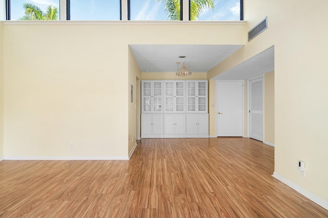 interior space featuring a chandelier and light wood-type flooring