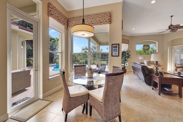 dining room with ornamental molding, a wealth of natural light, and baseboards