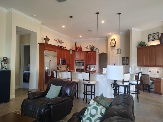 living area featuring arched walkways, crown molding, and recessed lighting