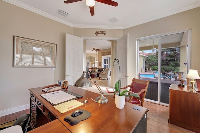 office space featuring ceiling fan, ornamental molding, wood finished floors, and visible vents