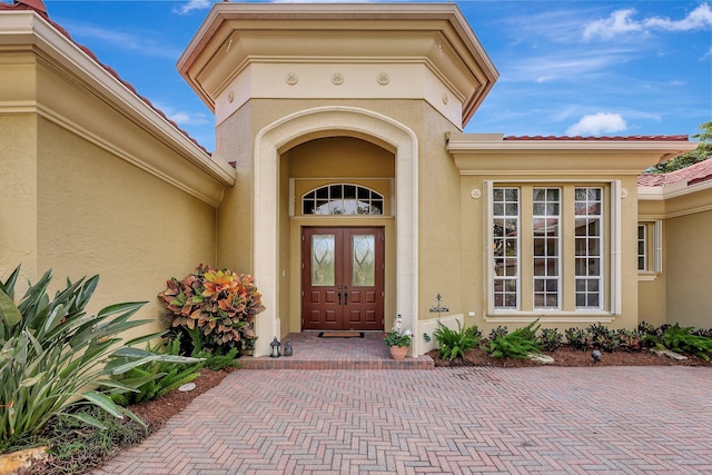 entrance to property with stucco siding