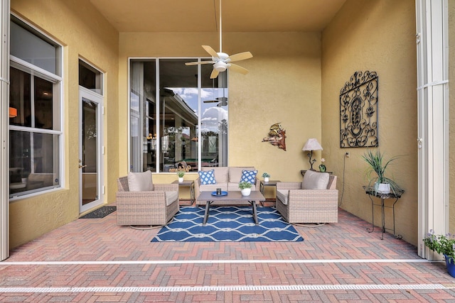 view of patio / terrace with ceiling fan and an outdoor living space