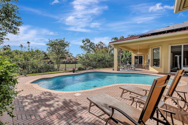 view of swimming pool featuring ceiling fan, outdoor dining area, a fenced backyard, a fenced in pool, and a patio area