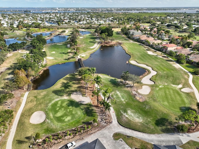 birds eye view of property with a water view and golf course view