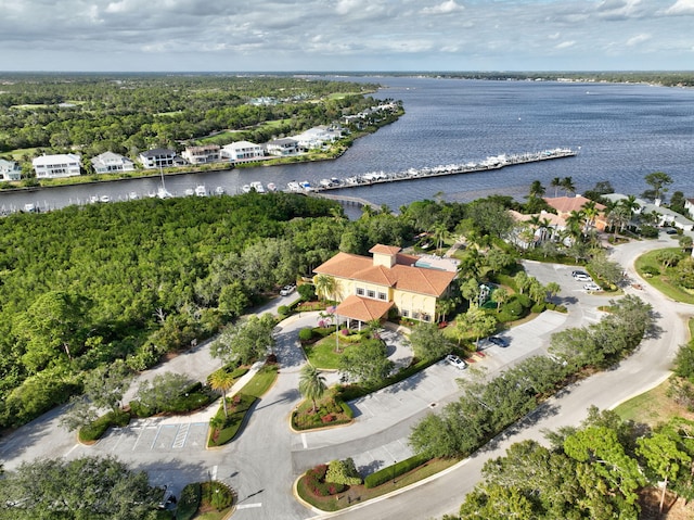 aerial view with a water view and a forest view