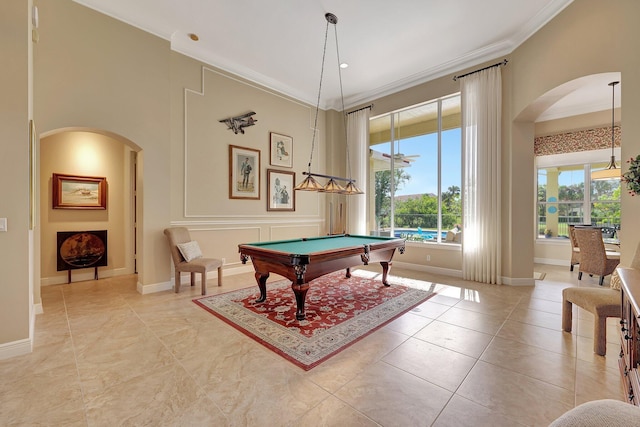 rec room with arched walkways, ornamental molding, light tile patterned flooring, billiards, and baseboards