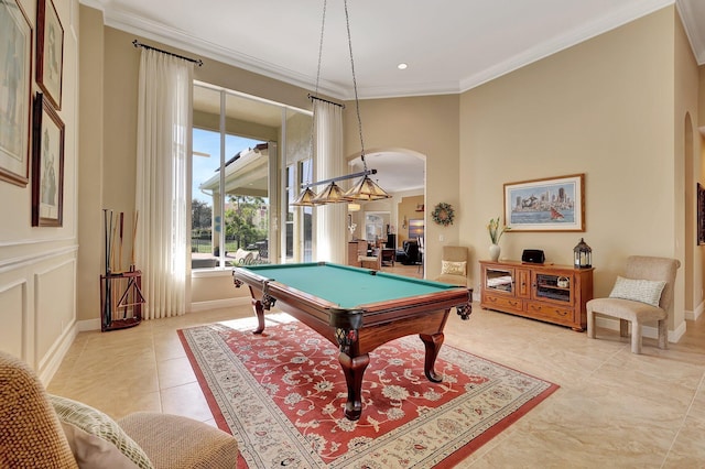 recreation room with arched walkways, pool table, baseboards, and crown molding