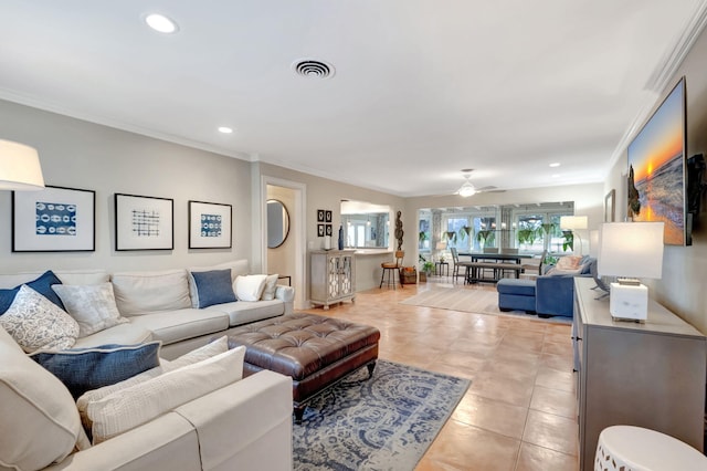 living room with light tile patterned floors, ceiling fan, and ornamental molding