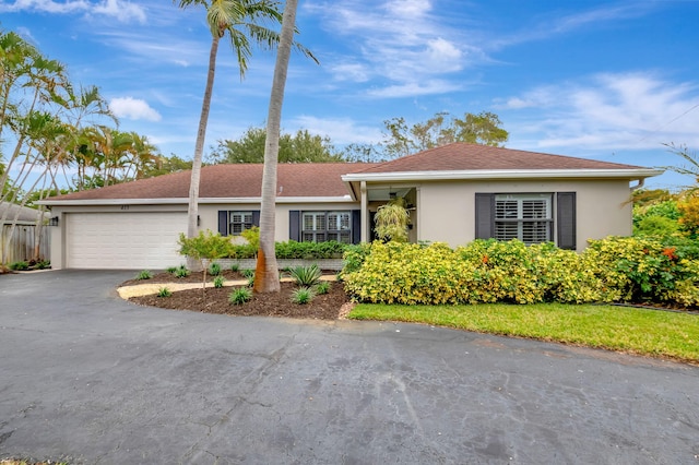 ranch-style home featuring a garage