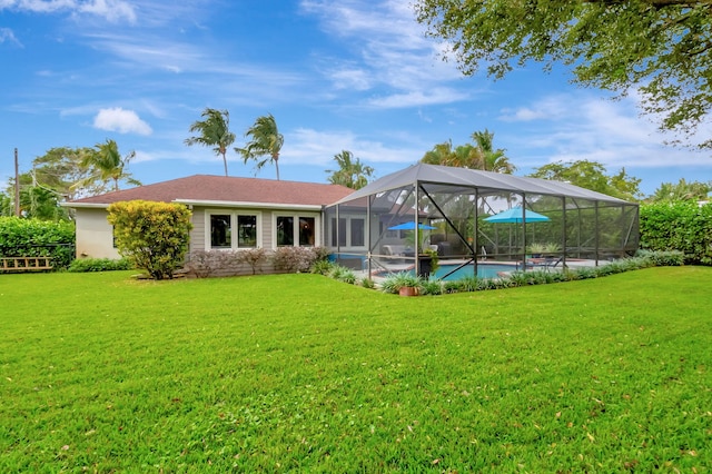 back of house featuring a lanai and a yard