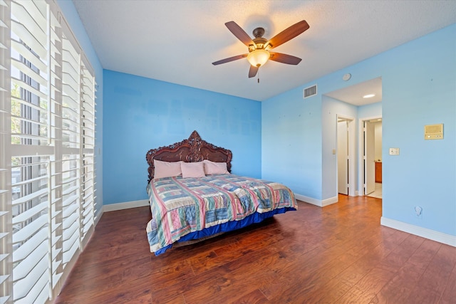 bedroom featuring ceiling fan and dark wood-type flooring