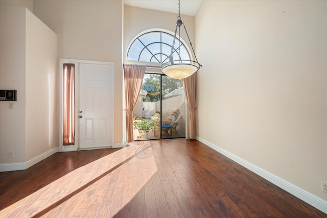 foyer entrance featuring a high ceiling and dark hardwood / wood-style floors