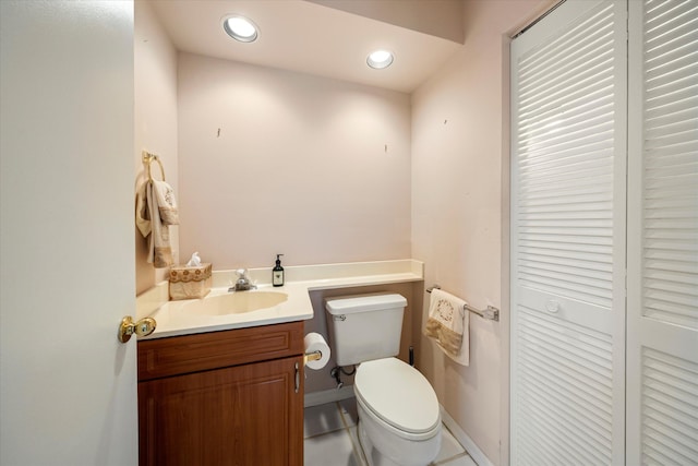 bathroom with tile patterned flooring, vanity, and toilet