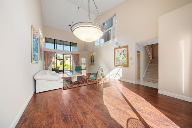 dining space featuring hardwood / wood-style floors and a towering ceiling